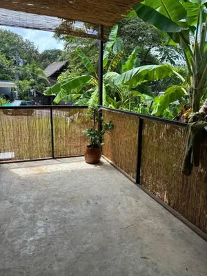 a patio with a fence and a potted plant at Salty studio apt Santa Teresa center in Santa Teresa Beach