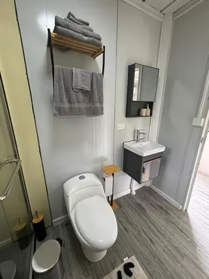 a bathroom with a toilet and a sink at Salty studio apt Santa Teresa center in Santa Teresa Beach