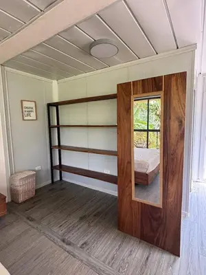 a bedroom with a bunk bed and a mirror at Salty studio apt Santa Teresa center in Santa Teresa Beach