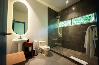 a bathroom with a toilet and a sink and a shower at Villa Marala in Esterillos