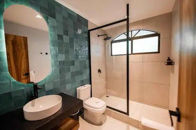 a bathroom with a toilet and a sink and a shower at Villa Marala in Esterillos