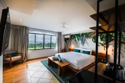 a bedroom with a bed and a large window at Villa Marala in Esterillos