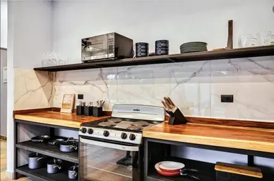 a kitchen with a stove and a counter top at El Castillo Casa Azul in Cuajiniquil