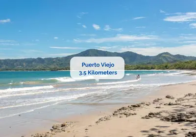 a beach with a sign that reads puerto vida kilometers at Mermaid House in Matapalo