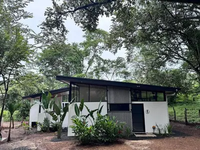a small house with a black roof at Mermaid House in Matapalo