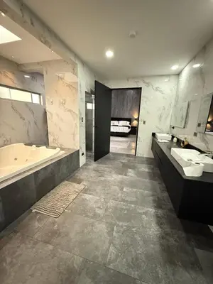 a large bathroom with a tub and two sinks and a bath tub at Penthouse 333 in Escazu