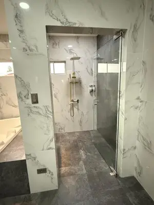 a bathroom with a shower with a glass door at Penthouse 333 in Escazu