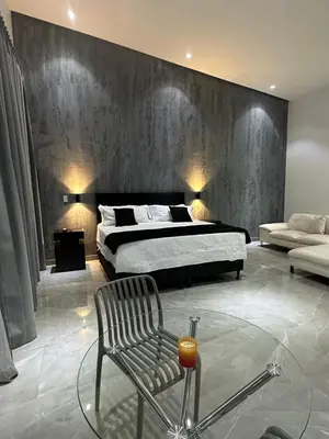 a bedroom with a bed and a chair and a couch at Penthouse 333 in Escazu
