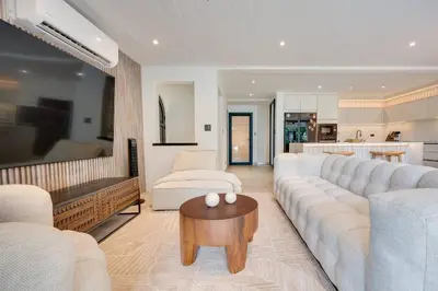 a living room with a large couch and a table at Seaside Hideaway Walk to Playa Flamingo Marina in Playa Flamingo
