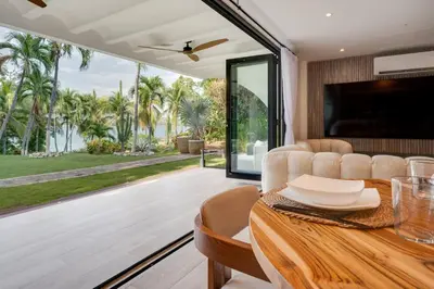a dining room with a table and a view of the ocean at Seaside Hideaway Walk to Playa Flamingo Marina in Playa Flamingo