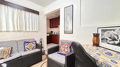 a living room with a couch and a chair at Apartamento San Juan in Santa Bárbaraa