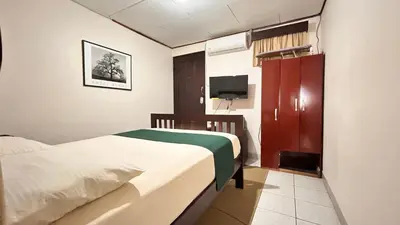 a small bedroom with a bed and a tv at Apartamento San Juan in Santa Bárbaraa