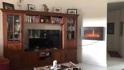 a living room with a tv and a fire place at The House of Encantada in Liberia