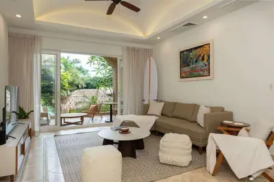 a living room with a couch and a table at Matapalo 202-Poolside Condo at Tamarindo in Tamarindo