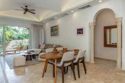 a living room with a table and a couch at Matapalo 202-Poolside Condo at Tamarindo in Tamarindo