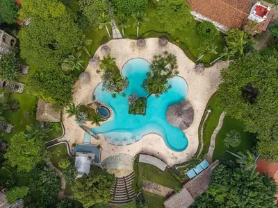 an overhead view of a swimming pool in a park at Matapalo 202-Poolside Condo at Tamarindo in Tamarindo