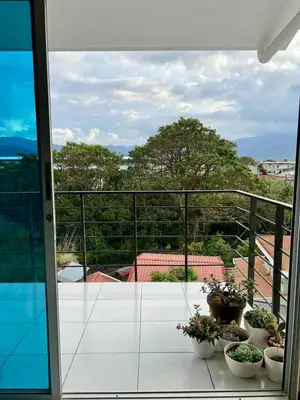 a balcony with several potted plants on a balcony at Daitares Home in San Pedro