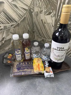 a bottle of wine and some food on a tray at Biofilia Monteverde in Monteverde Costa Rica