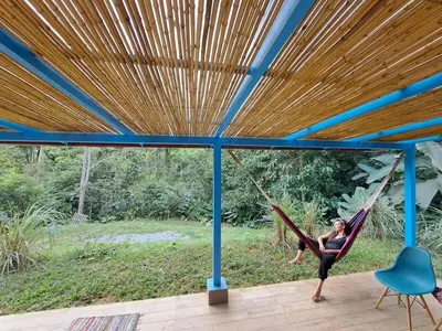 a woman swinging on a hammock in a house at Casa Alma in Platanillo