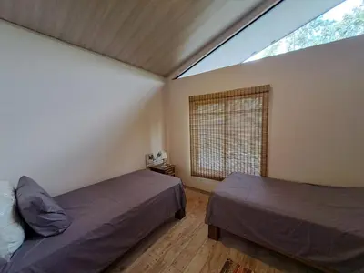 a bedroom with two beds and a large window at Casa Alma in Platanillo