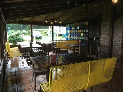 a restaurant with yellow chairs and tables and tables at Villa Calas in Vara Blanca