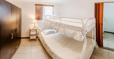 a bedroom with two bunk beds in a room at Toscana Escazú in San Rafael