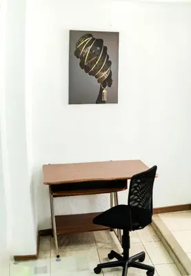 a desk with a chair and a picture on the wall at Toscana Escazú in San Rafael