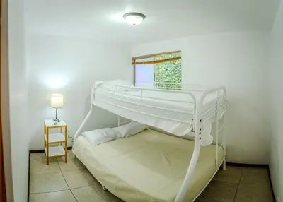 a white bunk bed in a room with a window at Toscana Escazú in San Rafael