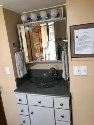 a bathroom with a sink and a mirror at Casa Hermosa FAM Little House in Santa María