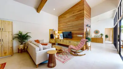 a living room with a couch and a tv at Casa Luna Rosa in Uvita