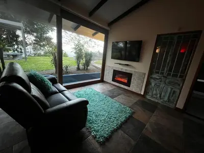 a living room with a couch and a fireplace at Casa Bali in San Francisco de Palmera