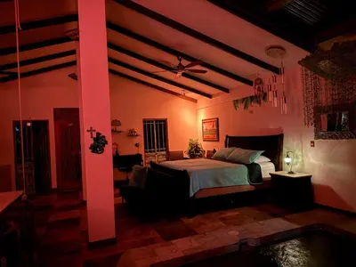 a bedroom with a bed and a ceiling fan at Casa Bali in San Francisco de Palmera