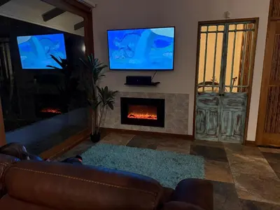 a living room with a couch and a fireplace at Casa Bali in San Francisco de Palmera