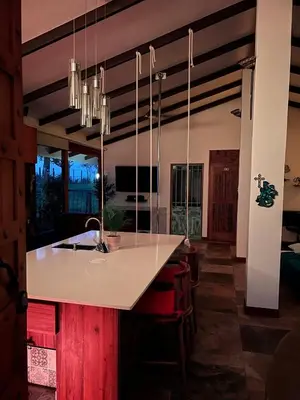 a kitchen with a large white island in a room at Casa Bali in San Francisco de Palmera