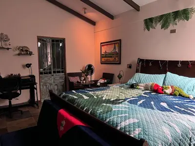 a child laying on a bed in a bedroom at Casa Bali in San Francisco de Palmera