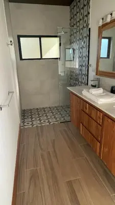 a bathroom with a shower and a sink and a mirror at Hacienda las colinas in Mesas