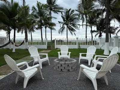 a group of white chairs and a fire pit with the beach at Luxury Beachfront in Playa Tivives, Puntarenas with Ocean Views,Pool in Tivives