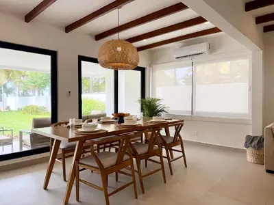 a dining room with a wooden table and chairs at Luxury Beachfront in Playa Tivives, Puntarenas with Ocean Views,Pool in Tivives