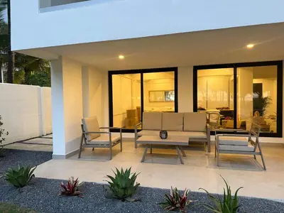 a patio with two chairs and a table at Luxury Beachfront in Playa Tivives, Puntarenas with Ocean Views,Pool in Tivives