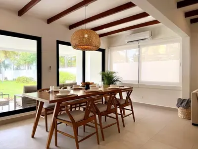 a dining room with a wooden table and chairs at Luxury Beachfront in Playa Tivives, Puntarenas with Ocean Views,Pool in Tivives