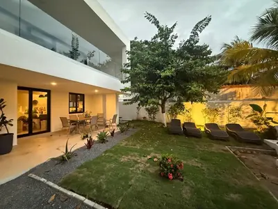 a house with a yard with chairs and a table at Luxury Beachfront in Playa Tivives, Puntarenas with Ocean Views,Pool in Tivives