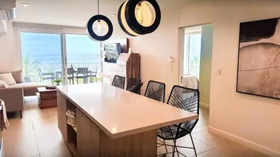 a kitchen with a table and chairs in a room at Pacific Point - Pure Vida in Jaco, Costa Rica in Jacó