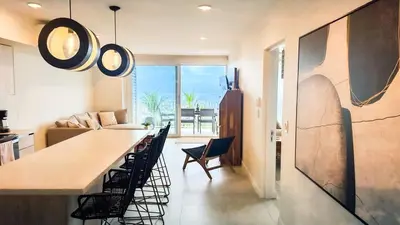 a kitchen and living room with a table and chairs at Pacific Point - Pure Vida in Jaco, Costa Rica in Jacó