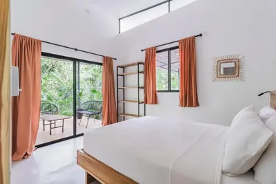 a bedroom with a white bed and a balcony at Casa con piscina privada a 700 m de Playa de Santa Teresa in Santa Teresa Beach