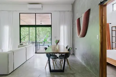 a dining room with a table and a couch at Casa con piscina privada a 700 m de Playa de Santa Teresa in Santa Teresa Beach