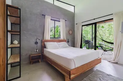 a bedroom with a bed and a large window at Casa con piscina privada a 700 m de Playa de Santa Teresa in Santa Teresa Beach