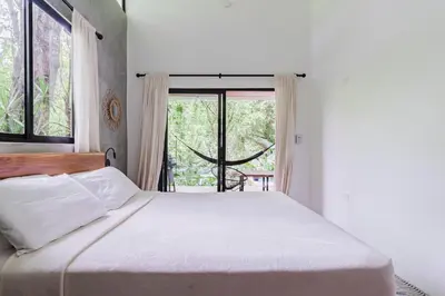 a bedroom with a large bed and a window at Casa con piscina privada a 700 m de Playa de Santa Teresa in Santa Teresa Beach