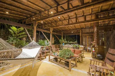 a patio with hammocks and a table and chairs at Casa Alma, Nature Escape with River, Trails and Views
