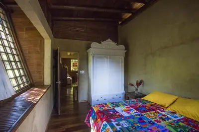 a bedroom with a bed with a colorful quilt at Casa Alma, Nature Escape with River, Trails and Views