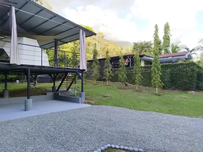 a view of a house with a pavilion in a yard at Osaglamping in Palmar Norte